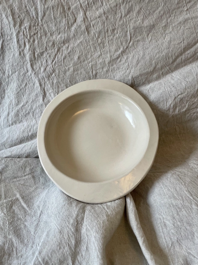 A round bowl with an asymmetric rim