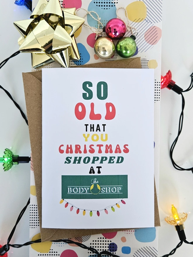 A photograph of the front of a humorous A6 greeting card illustrated using brightly coloured text and the retro shop logo. The text says so old you Christmas shopped at The Body Shop