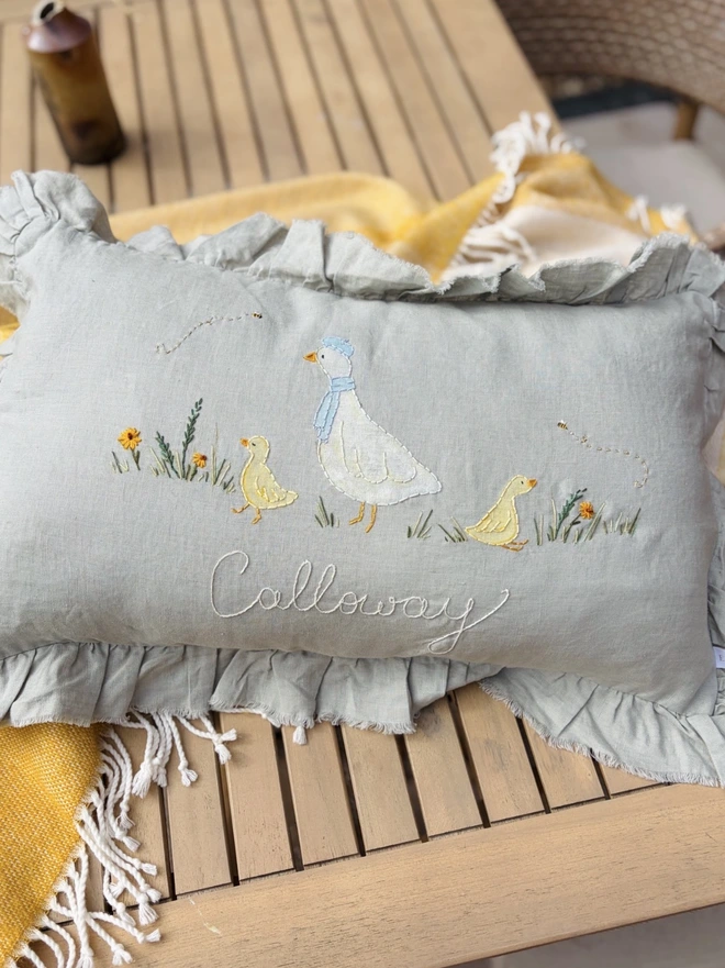 Hand Painted and Hand Embroidered Goose with baby geese on green linen cushion. Yellow flowers and bees. 