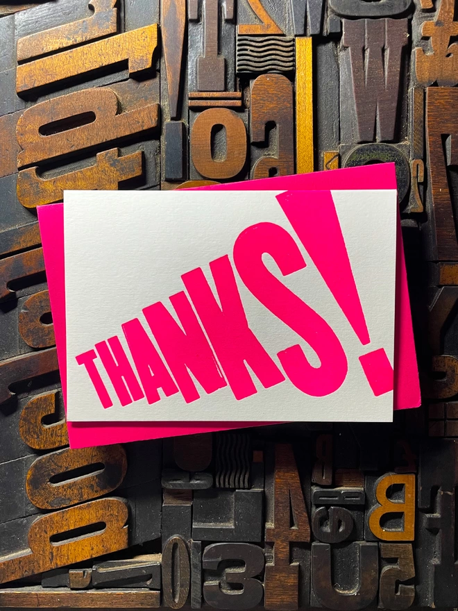 Thanks! A vibrant thank you typographic letterpress card with deep impression print using fluorescent pink, with a range of colourful envelopes. Slight print variations adding to the style anding to the charm of this handmade greeting card.