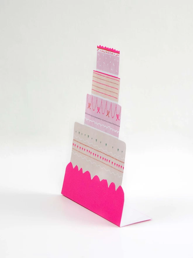 A Happy Cake celebration Card. Freestanding, die cut and neon. 