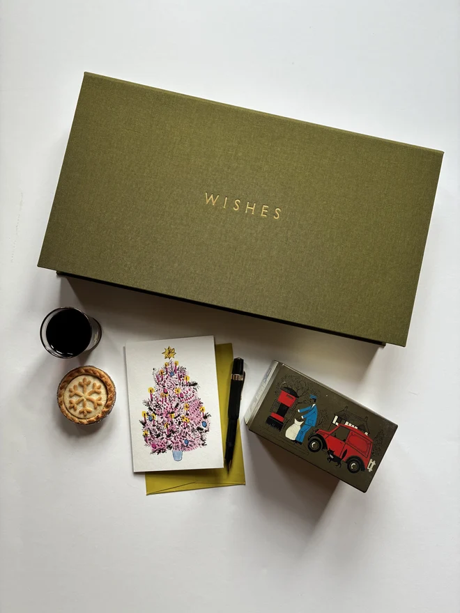 Closed handmade Christmas correspondence box in Olive green cloth with gold foiled personalisation and various stationery items