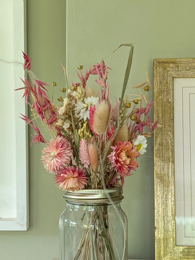 pink dried flowers in a glass jar