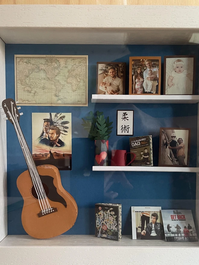 a wooden box with miniatures of the person favourite things inside. Each piece is handmade specially on request. bespoke art piece made by My Papercut Forest