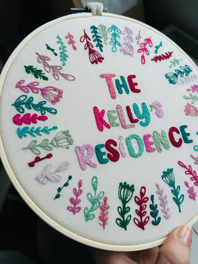 custom embroidered hoop. cotton hoop embroidered with multi coloured lettering.