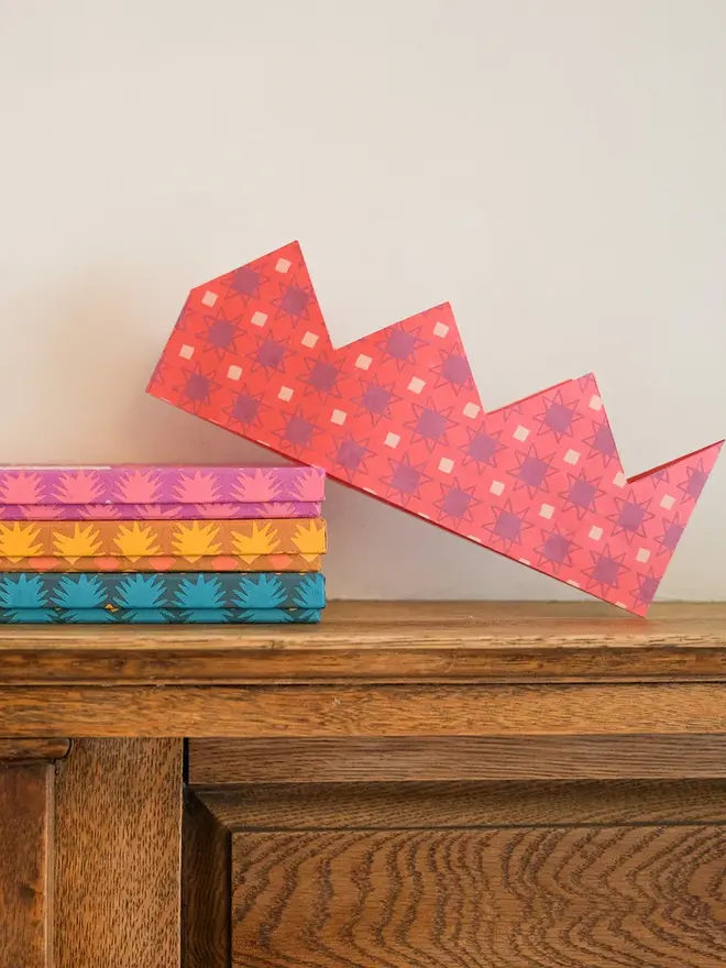 pink paper party crown with boxes