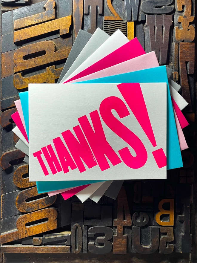 Thanks! A vibrant thank you typographic letterpress card with deep impression print using fluorescent pink, with a range of colourful envelopes. Slight print variations adding to the style anding to the charm of this handmade greeting card.