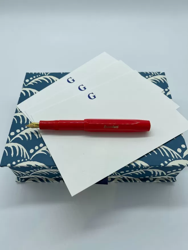 South London Letterpress with Navy Letter notecards seen with a red fountain pen and a blue patterned notecard box.