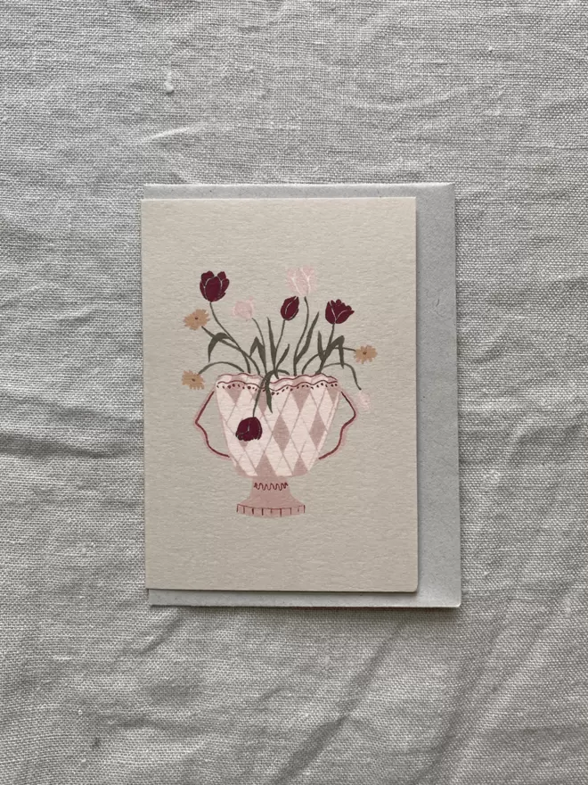 flowers in a harlequin vase on a greeting card 