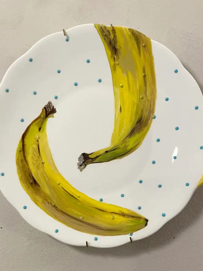 Oil Painted Banana On Vintage Cake Plate on a white background. 