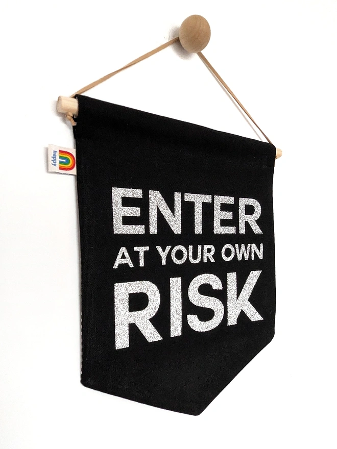 Non personalised option if "ENTE AT YOUR OWN RISK" banner. In black with silver glitter text. 