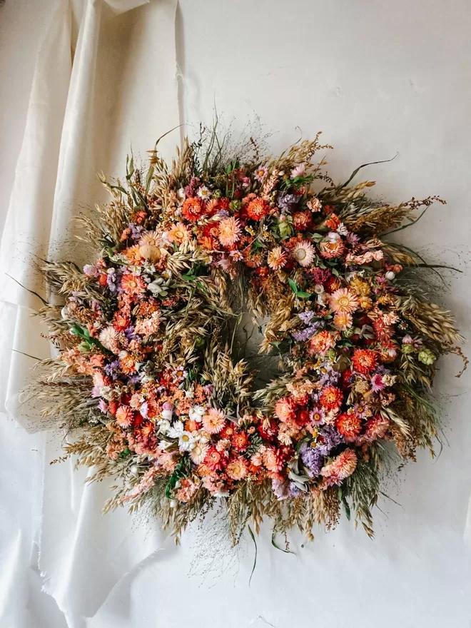 Ethereal wreath seen on a white wall