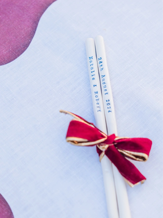 Wedding favour ceramic drinking straws with the names "Natalie & Robert" and the date "24th August 2024" 