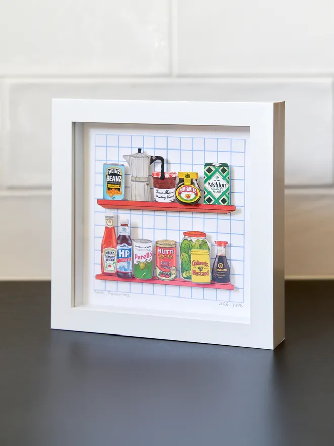 3D paper collage showing favourite cupboard staples on a shelve framed