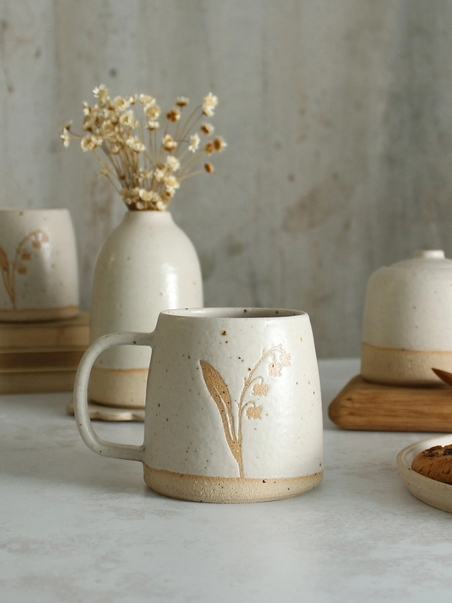 Lily of the valley white mug on table setting