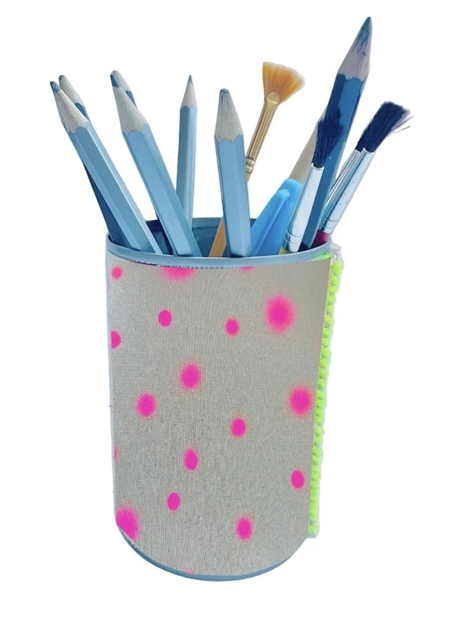 Upcycled & Repurposed Linen Tin Holder Polka Dot Print, a colourful polka dot tin on a white surface with pens and brushes in it. 
