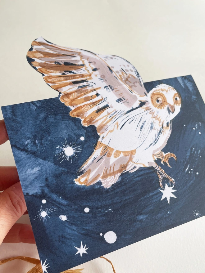 Esther Kent Night Owl illustrated greetings card shows a painterly white and brown owl on a dark blue sky. The wing folds out.