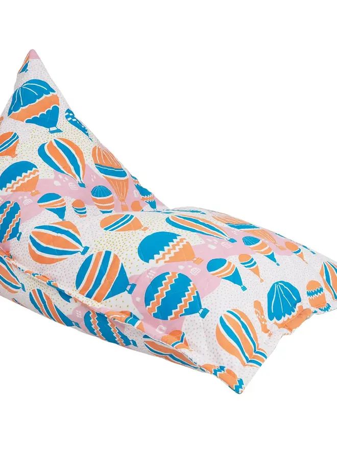 Balloons At Dawn Bean Bag Cover, a colourful bean bag sitting on a white floor. 