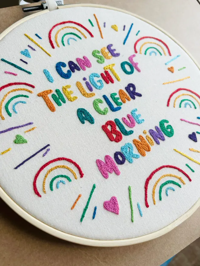 custom embroidered hoop. cotton hoop embroidered with multi coloured lettering.