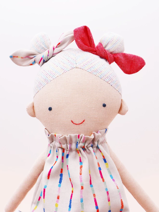 fabric girl doll with rainbow coloured hair and dress 