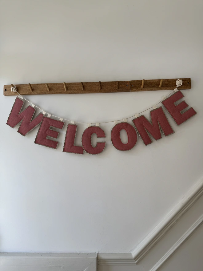 Linen Name Garland. A garland saying WELCOME in pink linen