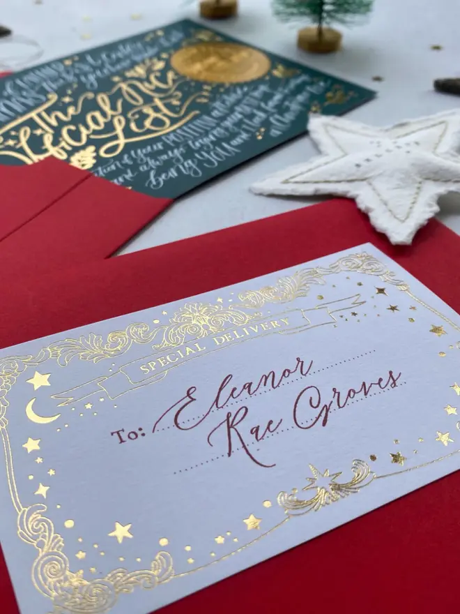 A gold foil "Special Delivery" label addressed to Eleanor Rae Groves on a red envelope.