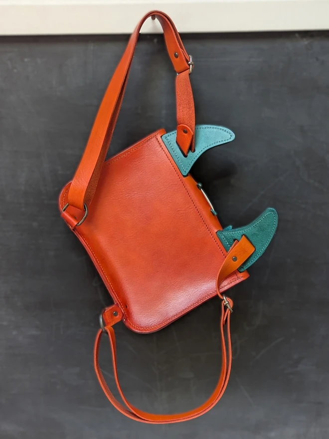 Leather monster backpack in orange and blue back view