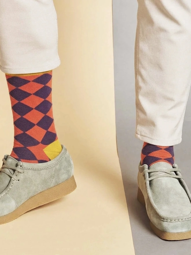 Men's Organic Cotton Ankle Socks Packs (Sets Of 3), a man wearing a pair of colourful patterned socks. 