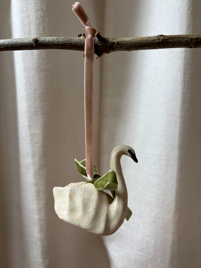 Ceramic swan Christmas tree decoration in white crackle glaze with velvet ribbon and bow