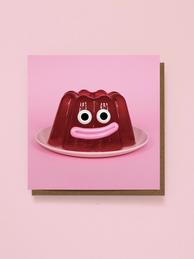 A smiling jelly on a pink plate 