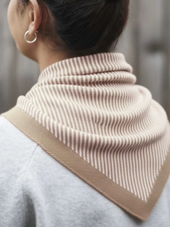 Lambswool Triangle Neck Scarf, a woman wearing a colourful neck scarf outdoors. 