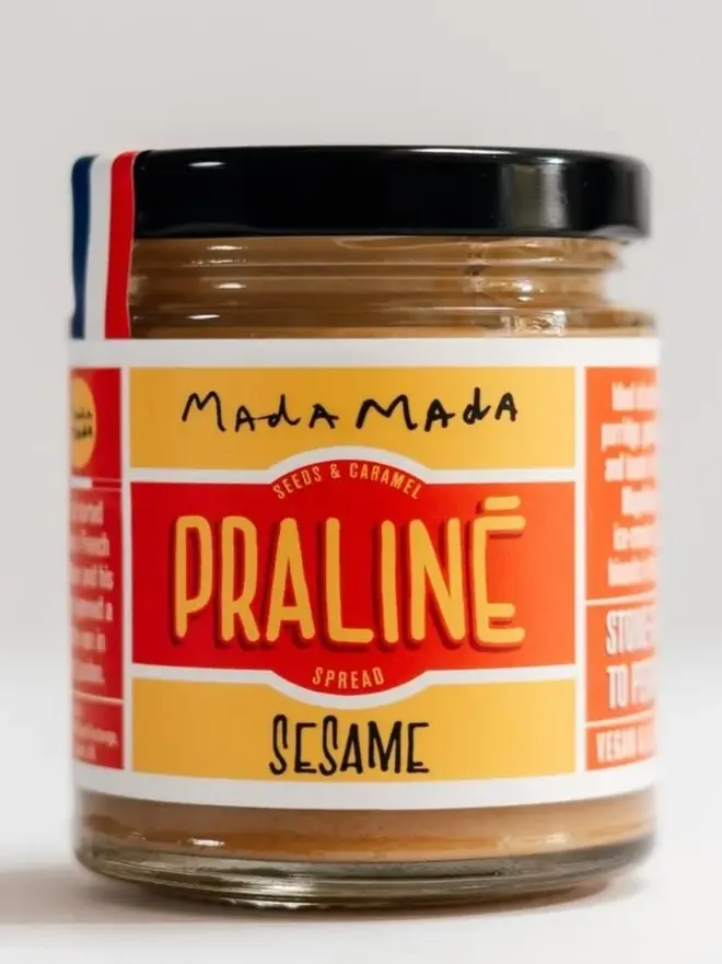 White Sesame Praline Spread, in a jar against a white background. 