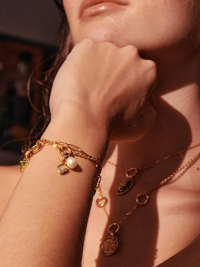 woman wearing bracelets with gold charms