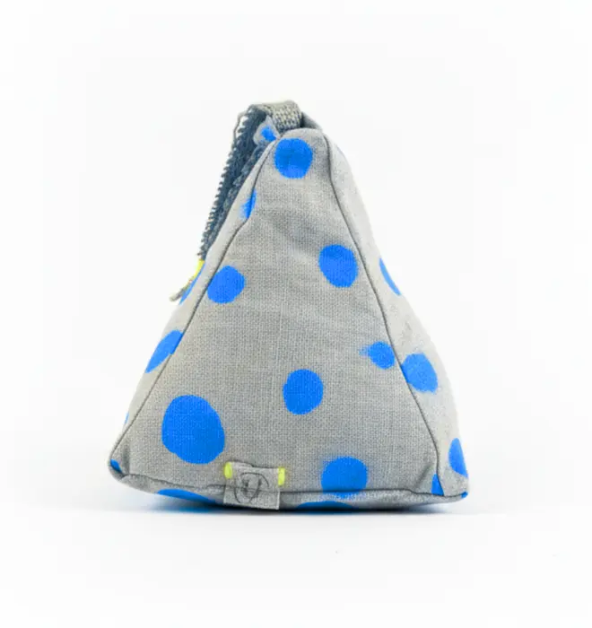 Hand Painted Linen Sustainable Doorstop In Polka Dot Print, a colourful neon blue doorstop against a white background. 