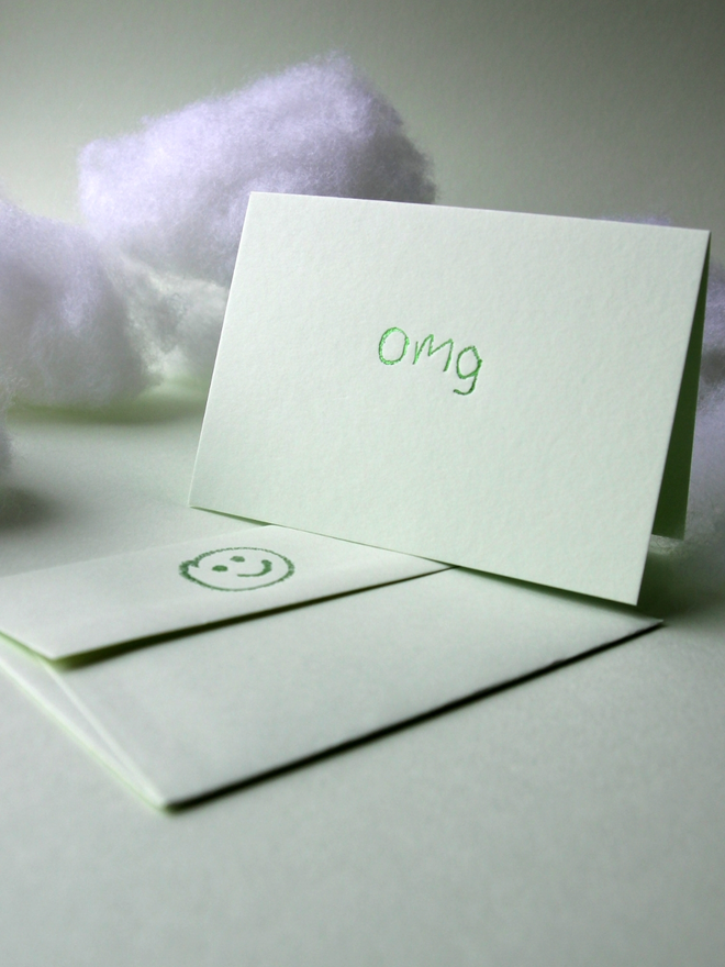 pistachio coloured card with omg short for 'oh my god' hand foiled in kids hand writing