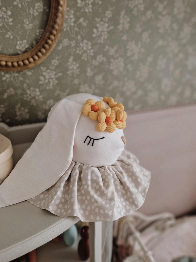 Rabbit Head Wall Mount, a cotton rabbit head wall decoration in a child's bedroom accompanied by other bedroom accessories. 