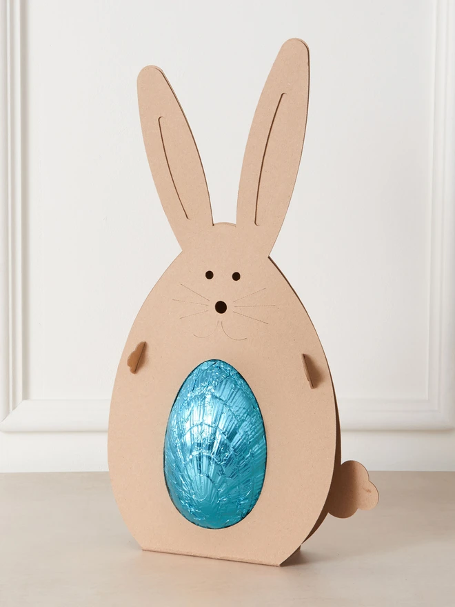 Maple & Pecan Dark Chocolate Easter Egg. a blue foil-wrapped easter egg inside a cardboard bunny. 