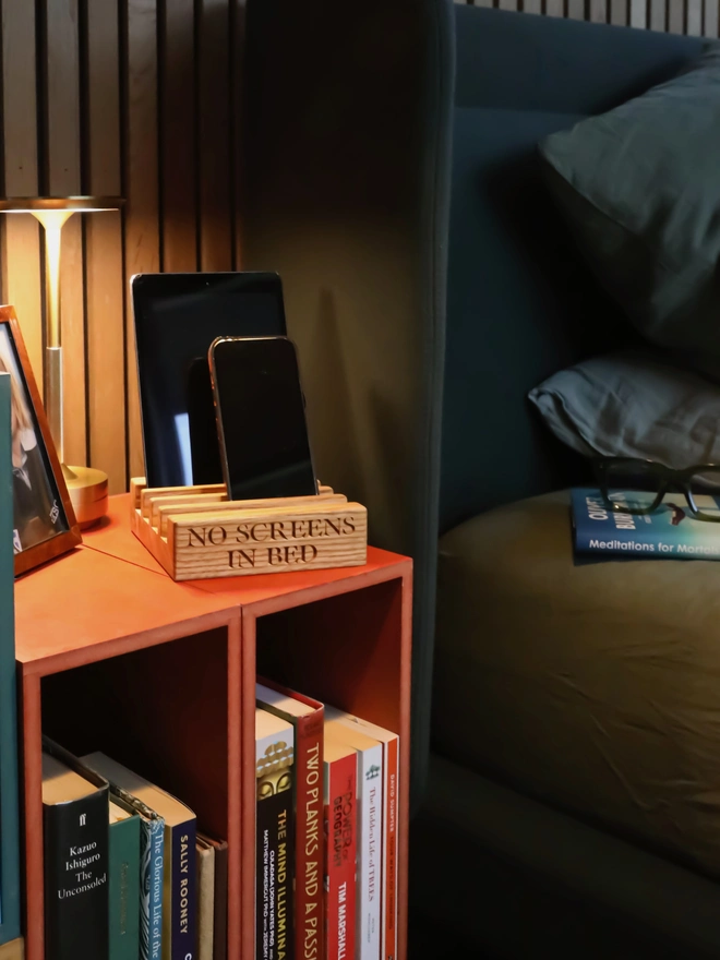 Phone or gadget stand next to a bed