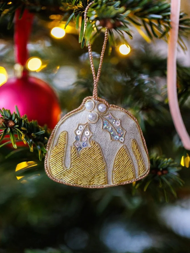 embroidered linen plum pudding decoration. embroidered beaded christmas pudding decoration hung on christmas tree.