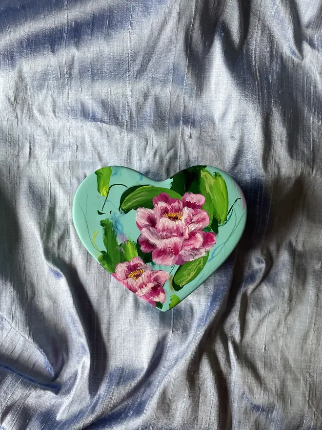 hand painted floral ceramic heart shaped keepsake box background in a pale blue with pink peony flowers