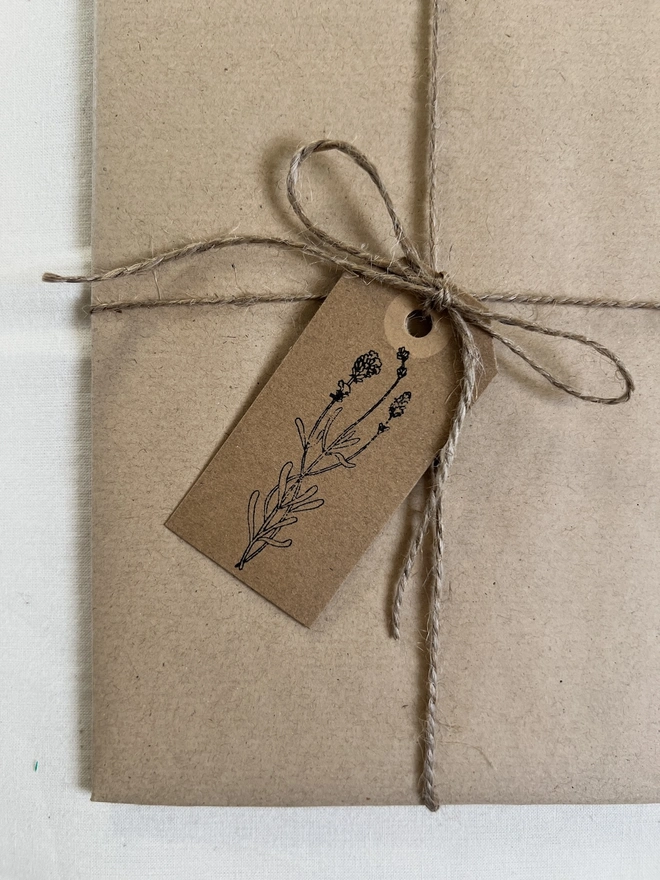 close up pf brown gift tag hand stamped with flower design