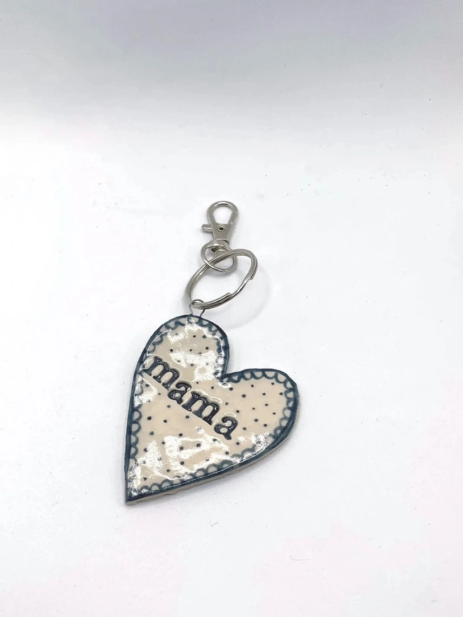 Mama Heart Ceramic Keyring, a blue keyring sitting on a plain white surface. 