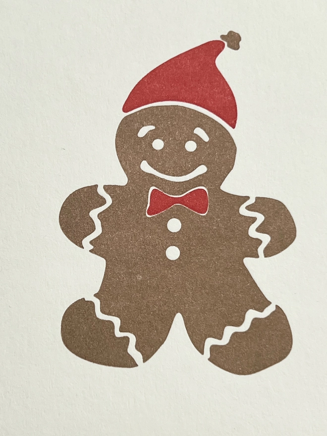 close up image of the red and gold gingerbread man