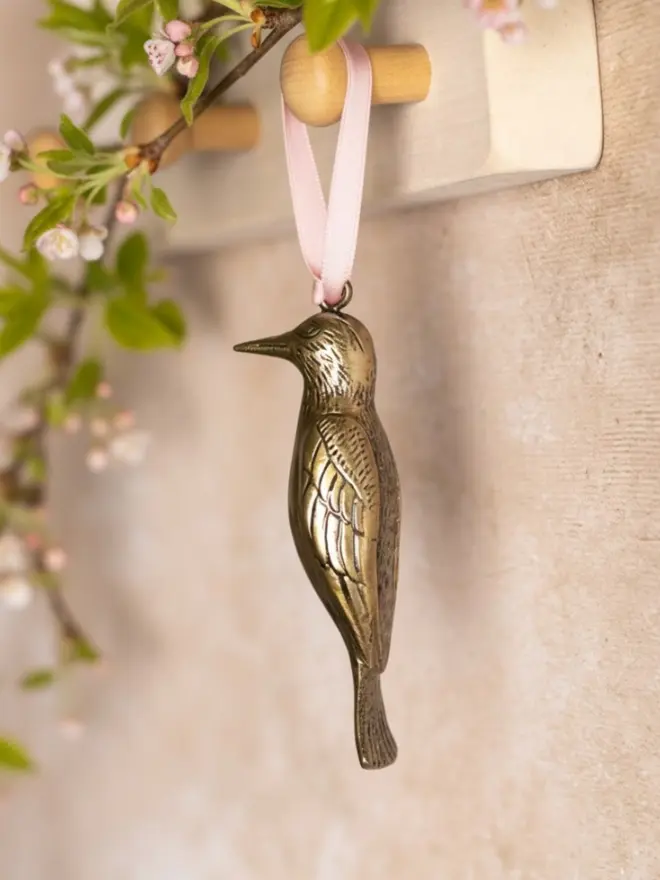 woodpecker metal hanging decoration hanging from wooden peg