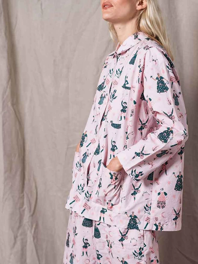 A close up of our pale pink pyjamas highlighting the two front pockets of the top and the icon print