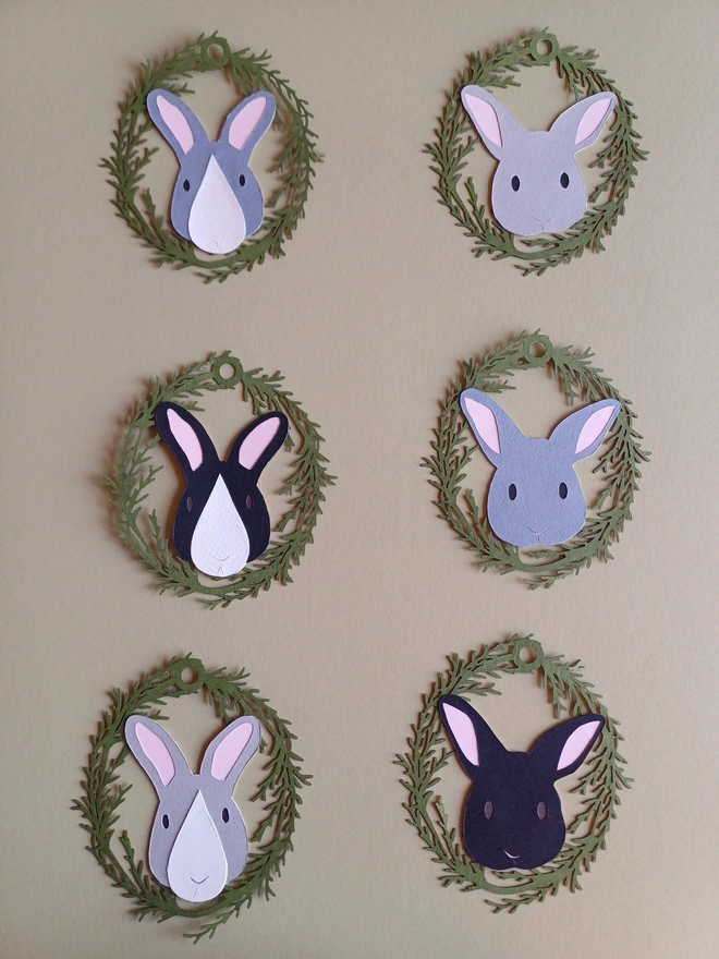 Grey and black Easter Bunny decorations - rabbit faces in a mix of dark and pale grey, black, some with white nose patches