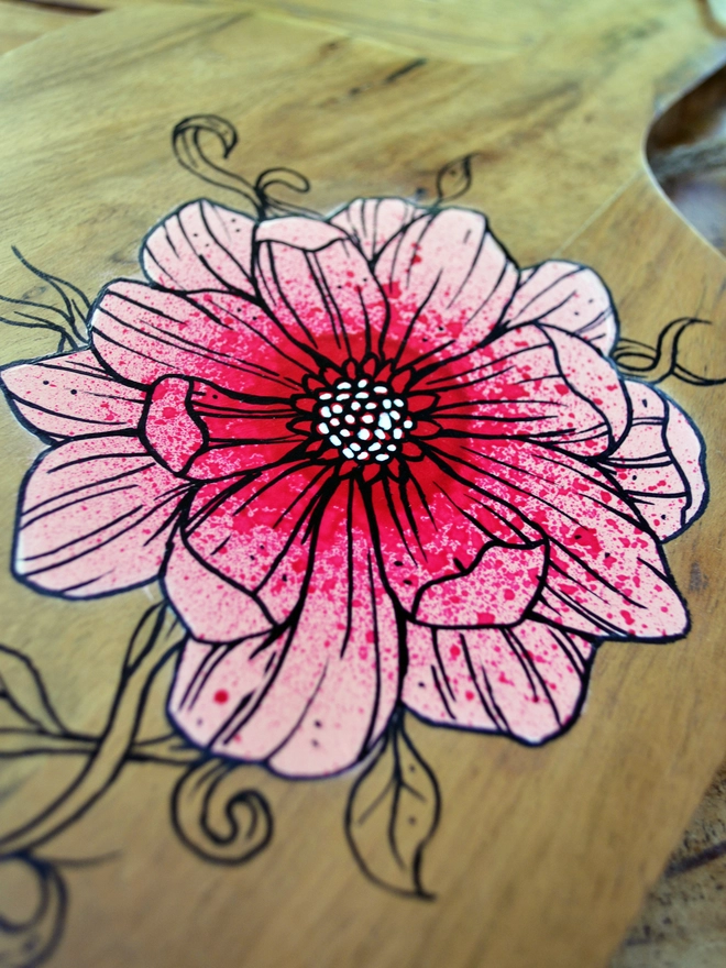 Detail of handpainted serving board with a design of roses