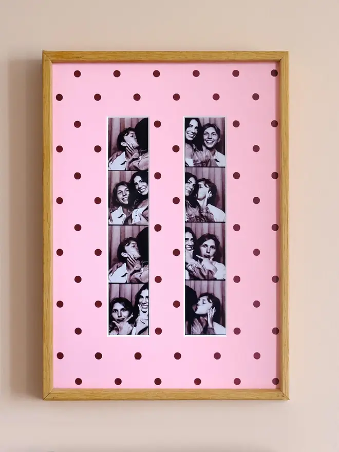 polka dot photo booth strip mount. a framed pink polka dot photo mount with two photo strips inside.