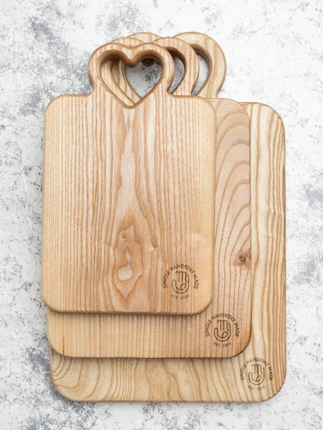 Heart Serving Boards (Set Of 3), on a marble surface. 