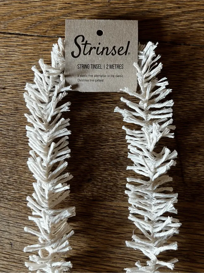 Original Strinsel with label AKA Jute string tinsel on an oak table